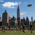 Players engaging in a New York Rugby match on a sunny day.